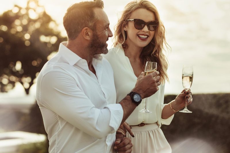A lady drinks amused sparkling wine with a callboy